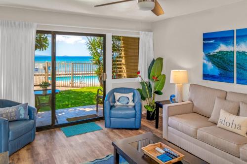 a living room with a view of the ocean at Hono Kai A5 in Wailuku