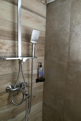 a shower with a shower head in a bathroom at Central Studio Apartments by Parkside Boutique in Skopje