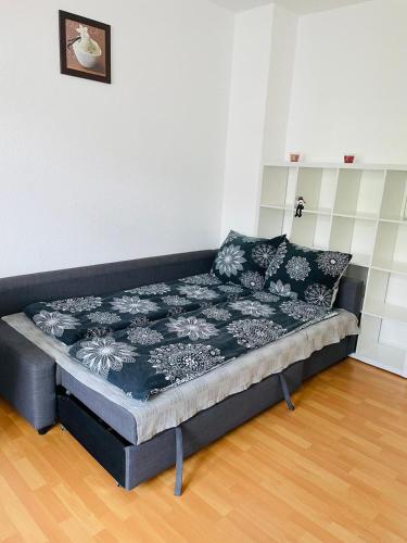a bed in a living room with a mattress at A&A Apartments in Chemnitz