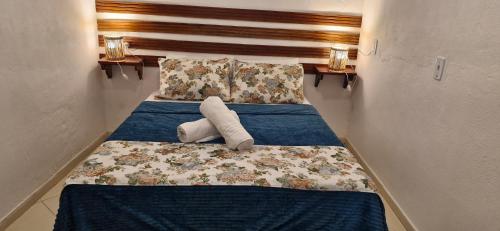 a room with a bed with a stuffed animal on it at Cores de Boipeba in Ilha de Boipeba
