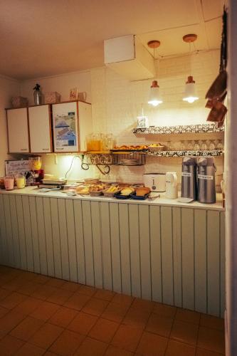 a kitchen with a counter with food on it at Los Calafates Hotel in Ushuaia