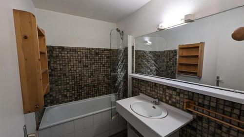 une salle de bain avec un lavabo, un miroir et une baignoire dans l'établissement Résidence Meijotel - Studio résidence Meijotel MAE-9381, à Vénosc