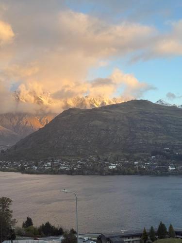 a view of a mountain with a body of water at Goldrush #1 in Queenstown