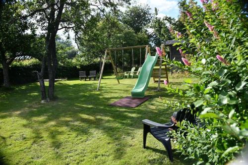 a park with a playground with a slide at Gîte tout confort au cœur du Parc national de la vallée de la Semois in Ucimont