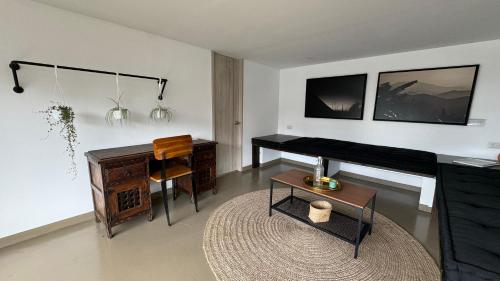 a living room with a piano and a desk at Ope Suites calle 100 in Bogotá