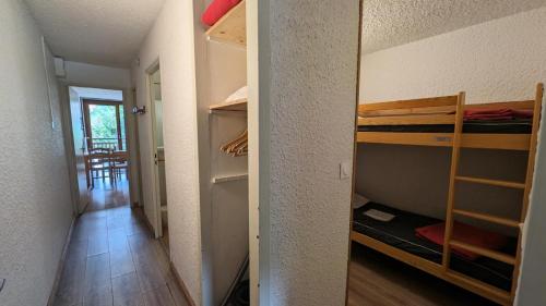 Cette chambre comprend 2 lits superposés et un couloir. dans l'établissement Résidence Meijotel - Studio résidence Meijotel MAE-9291, à Vénosc
