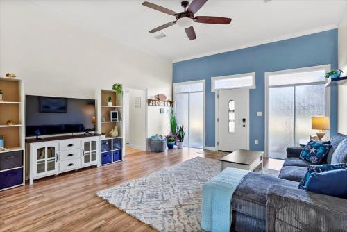a living room with a couch and a ceiling fan at Endless Summer Retreat with Private Pool near Beach in Gautier
