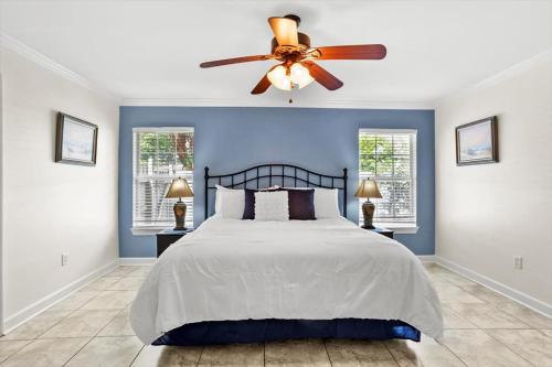 a bedroom with a bed with a ceiling fan at Endless Summer Retreat with Private Pool near Beach in Gautier