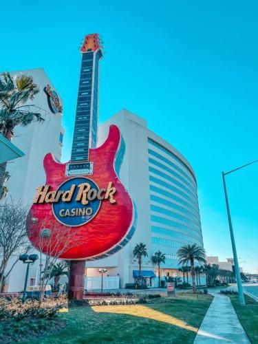 a large red guitar sign in front of a hotel at Endless Summer Retreat with Private Pool near Beach in Gautier
