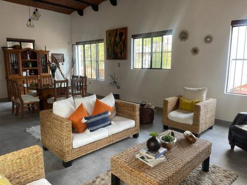 a living room with a couch and two chairs and a table at Casa Moly in Guanajuato