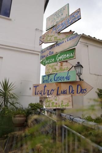 a street sign with many signs in different languages at Dimora Amina in Loreto Aprutino