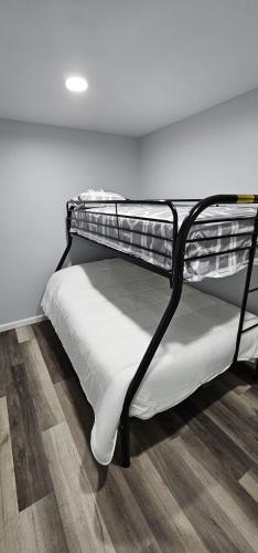 a bunk bed in a room with a wooden floor at Aria Pocono Home in Tobyhanna
