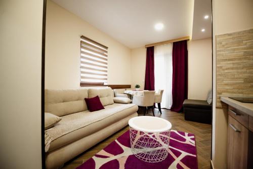 a living room with a couch and a table at Apartmani Jela Zlatar in Vukovina