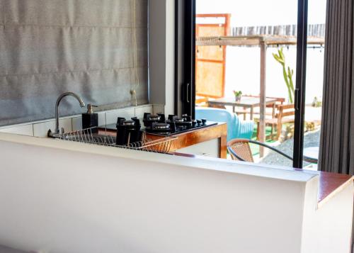 a kitchen with a sink and a stove top at Che Lobitos in Lobitos