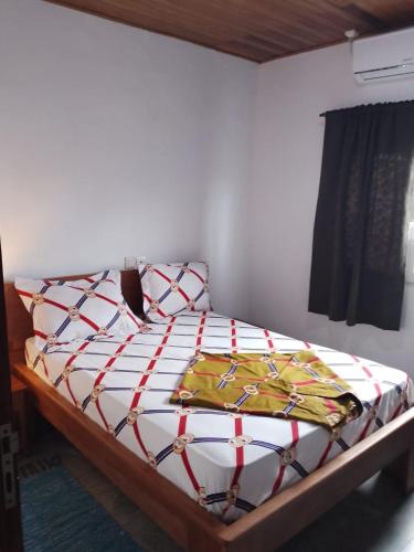a bed sitting in a room with at Résidence Merveilles D20 in Kribi