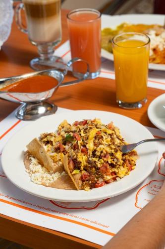a plate of food on a table with a plate of food at Hotel Real Plaza in San Luis Potosí