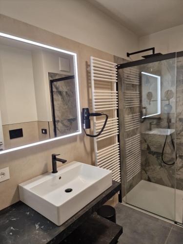 a bathroom with a white sink and a shower at Agriturismo Borgo Riva Granda in Col San Martino