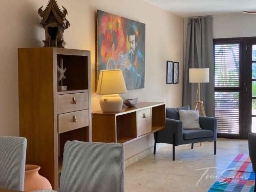 a living room with a dresser and a chair and a lamp at CABARETE BEACH HOUSES the NANNY ESTATES in Cabarete