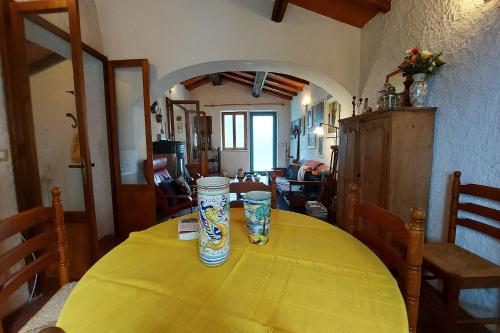 a table with two vases sitting on top of it at Family Friendly Rosa House Amazing View - Happy Rentals in Barga