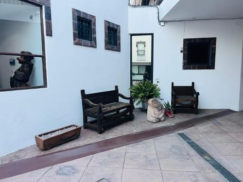 a room with two benches and a mirror on a wall at QA Hotel in San Luis Potosí