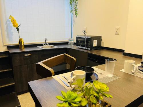 a kitchen with a table and a microwave at QA Hotel in San Luis Potosí