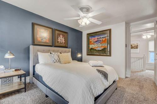 a bedroom with a large bed and a ceiling fan at Tiger Lair Walk to CC Historic Downtown COS 4BR in Colorado Springs