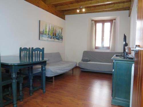a living room with a table and a couch at MIÑO 29 Viviendas turisticas in Lugo