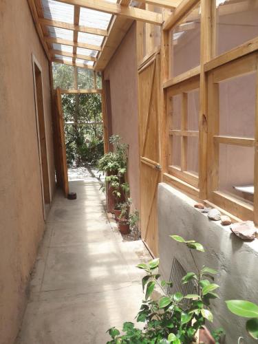 an empty hallway in a building with plants at Casa Rivera in Rivadavia