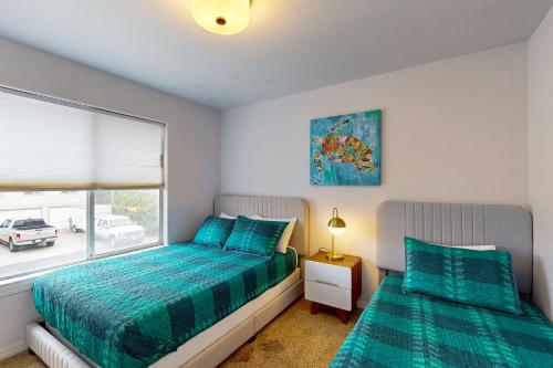 a bedroom with two beds and a window at Victorian Dream in Arroyo Grande