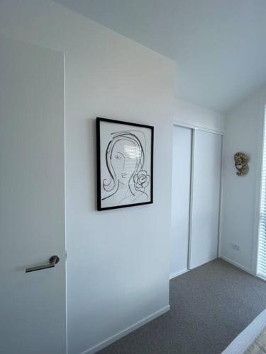 a drawing of a woman is on a wall at Island ambience in the heart of Matakana in Matakana