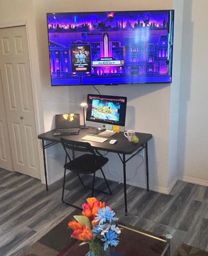 a desk with a computer and a laptop on it at Cozy Sanctuary in Jersey City