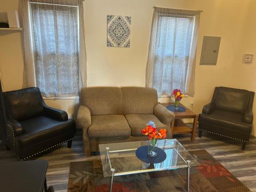 a living room with a couch and two chairs at Cozy Sanctuary in Jersey City