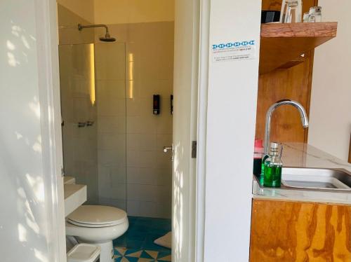 a bathroom with a toilet and a sink at Studios Downtown Cancun in Cancún
