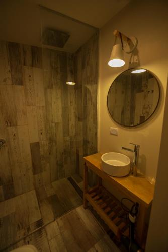 a bathroom with a sink and a mirror at Los Calafates Hotel in Ushuaia