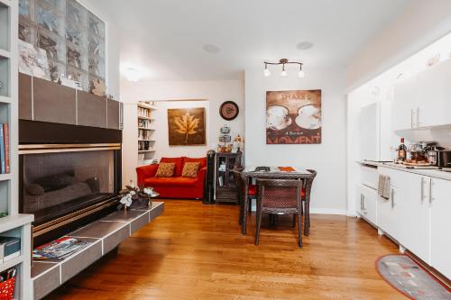a living room with a fireplace and a red couch at Along River Ridge in Calgary
