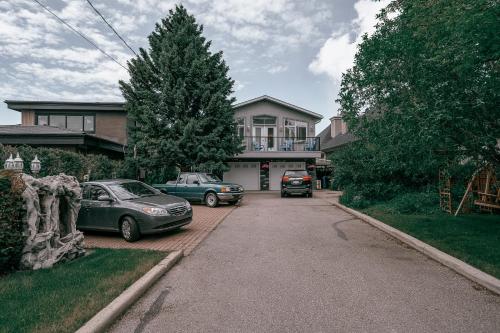 two cars parked in front of a house at Along River Ridge in Calgary