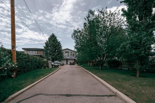 an empty street in front of a house at Along River Ridge in Calgary