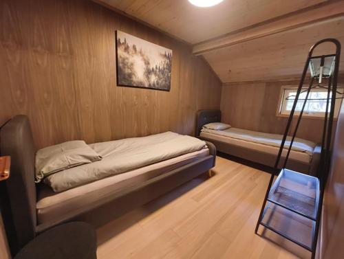 a small room with a bed and a bunk bed at OlaHytta - Cozy cabin close to kvitfjell in Tromsnes