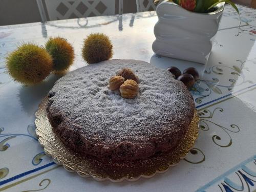 a chocolate cake with nuts on a table with flowers at Terra Vitale in Cava deʼ Tirreni
