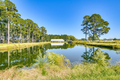 a river with trees and a bridge in the background at House on 20 Acres with On-Site Pond in Spring Lake! in Spring Lake