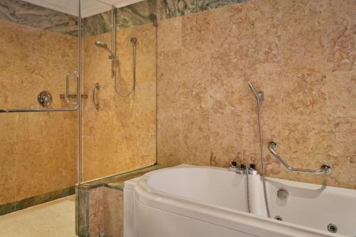 a bathroom with a bath tub and a shower at Penha Longa Resort in Sintra