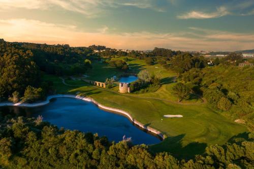 an aerial view of a golf course with a lake at Penha Longa Resort in Sintra