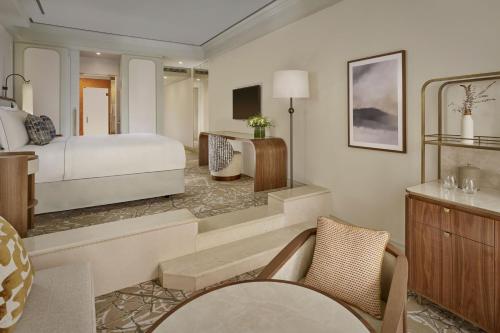 a bedroom with a bed and a living room at Penha Longa Resort in Sintra
