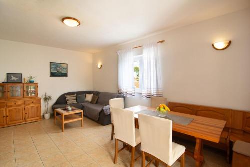 a living room with a table and a couch at Apartment Ivope in Splitska