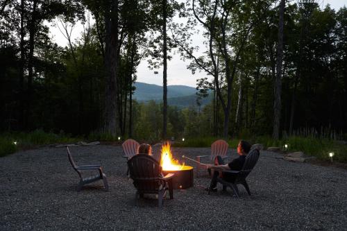 a group of people sitting around a fire at Coldbrook Bed and Breakfast in Bearsville