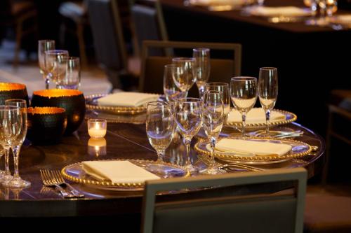 a table with wine glasses and plates and napkins at Renaissance Tampa International Plaza Hotel in Tampa