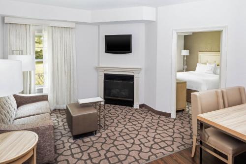 a hotel room with a bed and a living room at Residence Inn by Marriott West Orange in West Orange