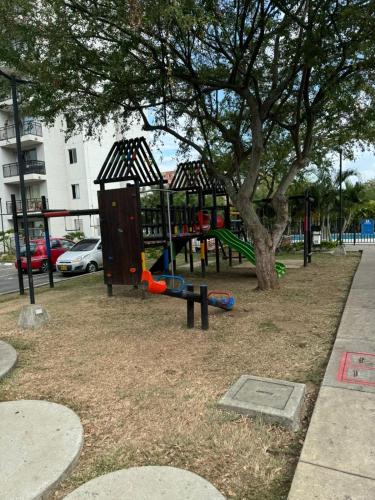 a park with a playground with a tree at Apartamento Paula in Cali
