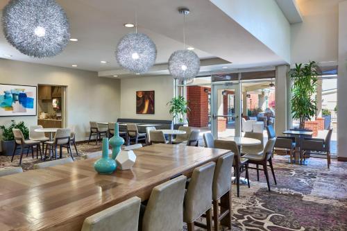 a dining room with a large wooden table and chairs at Residence Inn by Marriott Nashville South East/Murfreesboro in Murfreesboro