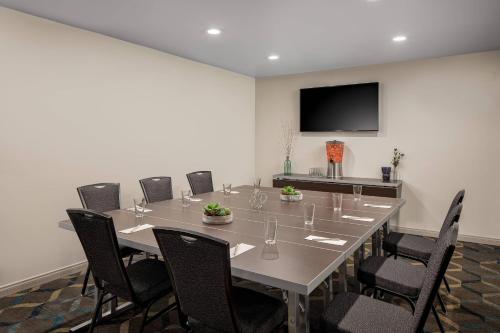 a conference room with a large table and chairs at Residence Inn Pasadena Arcadia in Arcadia